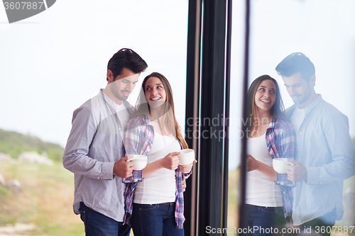 Image of relaxet young couple drink first morning coffee