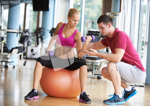 Image of young sporty woman with trainer exercise weights lifting