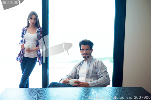 Image of relaxet young couple drink first morning coffee