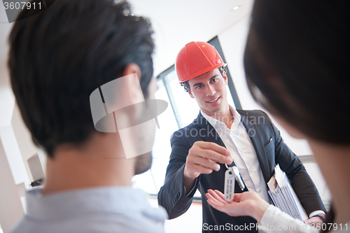 Image of couple buying new home with real estate agent