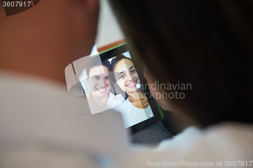Image of couple at modern home using tablet computer