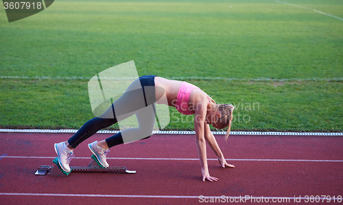 Image of pixelated design of woman  sprinter leaving starting blocks