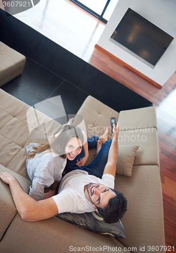 Image of young couple watching tv at home