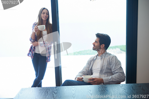 Image of relaxet young couple drink first morning coffee