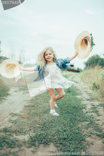 Image of The young girl on green grass background 