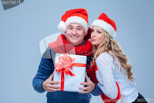 Image of Lovely christmas couple holding presents