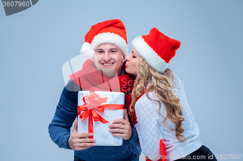 Image of Lovely christmas couple holding presents