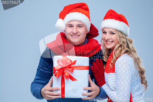 Image of Lovely christmas couple holding presents