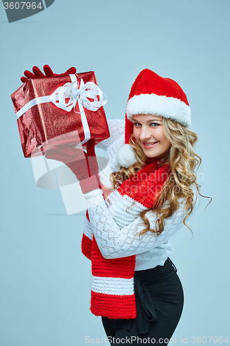 Image of Beautiful young woman in Santa Claus clothes