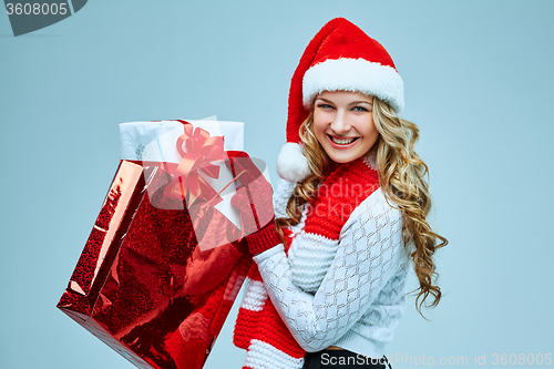 Image of Beautiful young woman in Santa Claus clothes