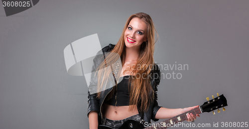 Image of Beautiful girl playing guitar