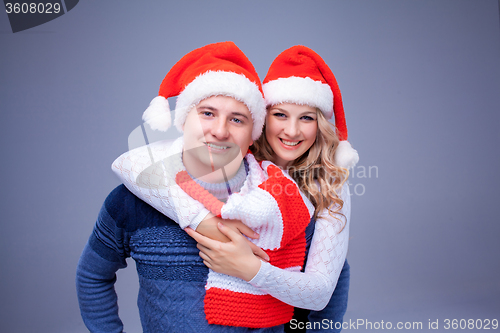 Image of Lovely christmas couple in Santa Claus hats