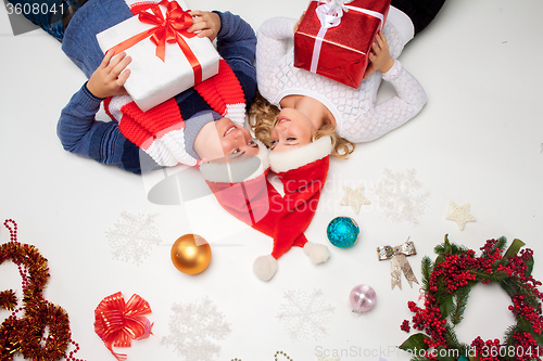 Image of Lovely christmas couple lying with presents