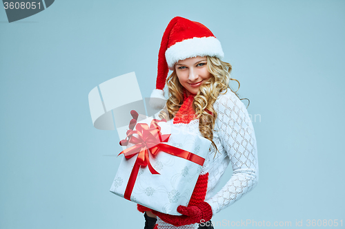 Image of Beautiful young woman in Santa Claus clothes
