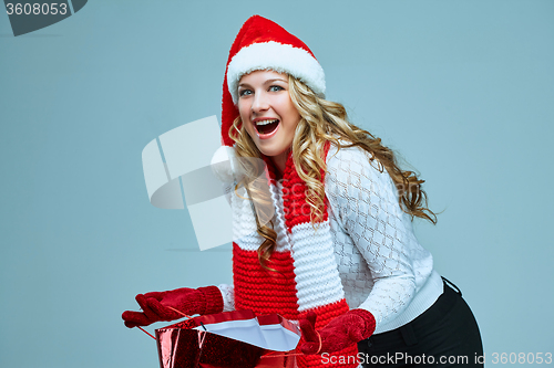 Image of Beautiful young woman in Santa Claus clothes