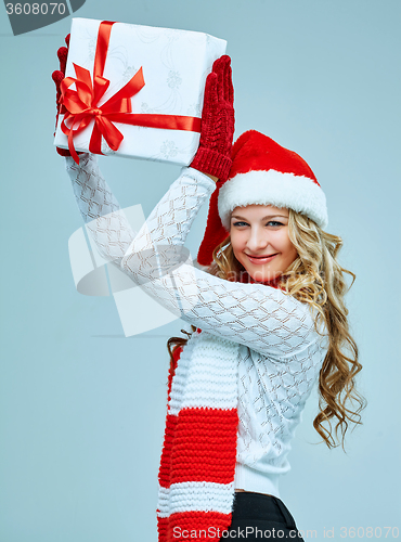 Image of Beautiful young woman in Santa Claus clothes