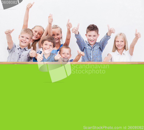 Image of The smiling teenagers showing okay sign on white 