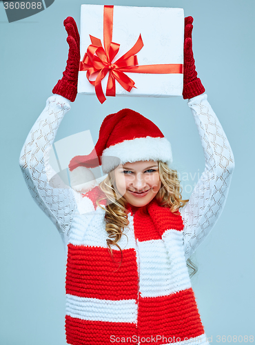 Image of Beautiful young woman in Santa Claus clothes