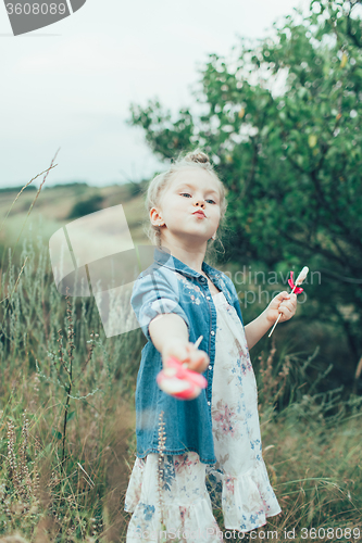 Image of The young girl on green grass background 