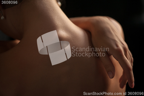 Image of Beautiful woman, back view on dack background