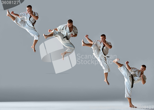 Image of Man in white kimono training karate