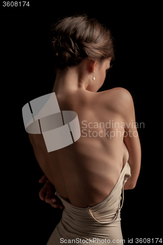 Image of Beautiful woman, back view on dack background