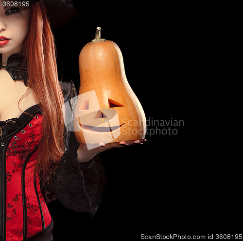 Image of Girl with Halloween pumpkin on black background