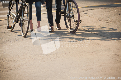 Image of Young couple sitting on a bicycle opposite the city 