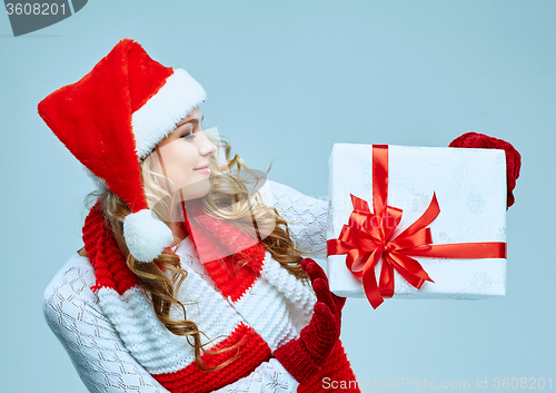 Image of Beautiful young woman in Santa Claus clothes