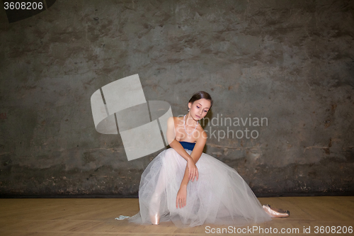 Image of The beautiful ballerina posing in long white skirt 