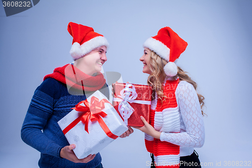 Image of Lovely christmas couple holding presents