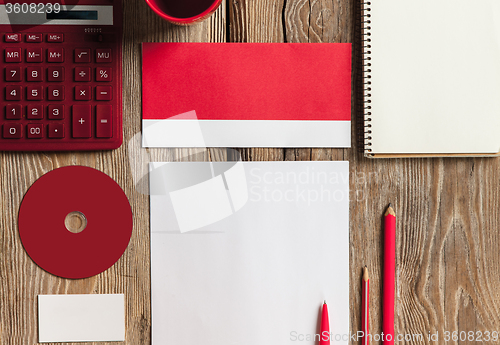 Image of The mockup on wooden background with red calculator