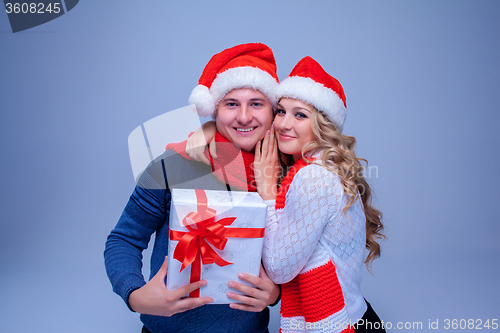 Image of Lovely christmas couple holding presents