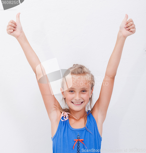 Image of Portrait of a beautiful girl showing thumbs up on white