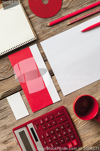 Image of The mockup on wooden background with red calculator