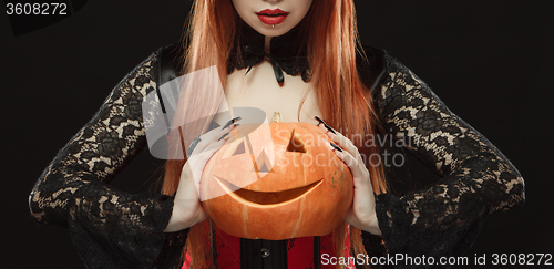 Image of Girl with Halloween pumpkin on black background