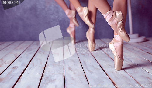 Image of The feet of a young ballerinas in pointe shoes 