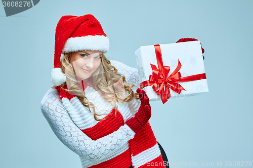 Image of Beautiful young woman in Santa Claus clothes