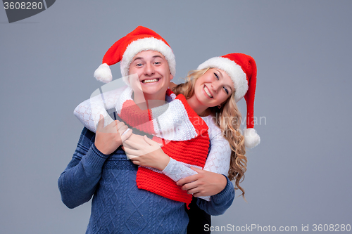 Image of Lovely christmas couple in Santa Claus hats