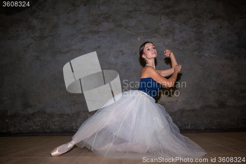 Image of The beautiful ballerina posing in long white skirt 