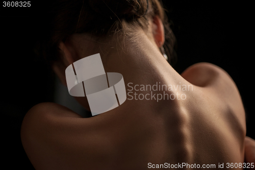 Image of Beautiful woman, back view on dack background