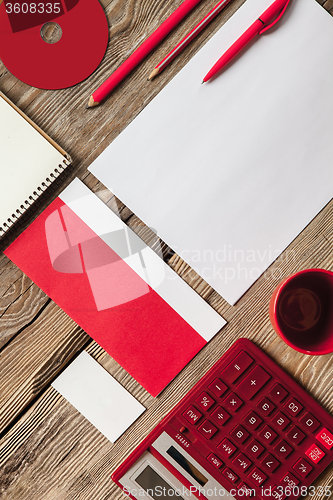 Image of The mockup on wooden background with red calculator