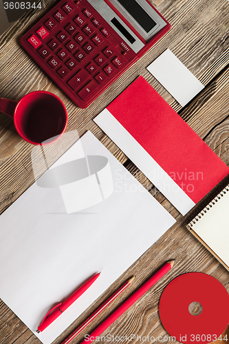 Image of The mockup on wooden background with red calculator
