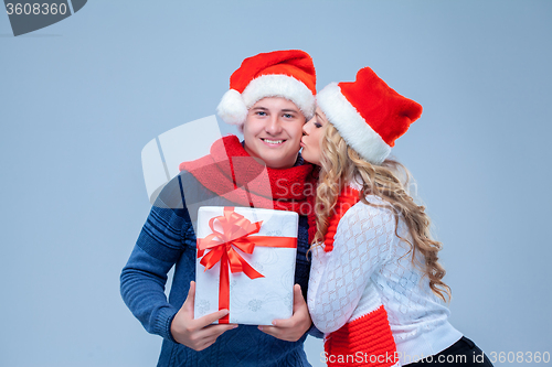 Image of Lovely christmas couple holding presents