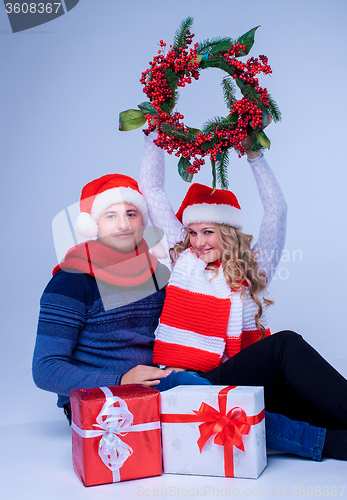 Image of Lovely christmas couple holding presents