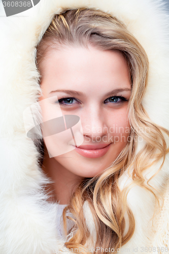 Image of Portrait of blond young woman in fur coat 