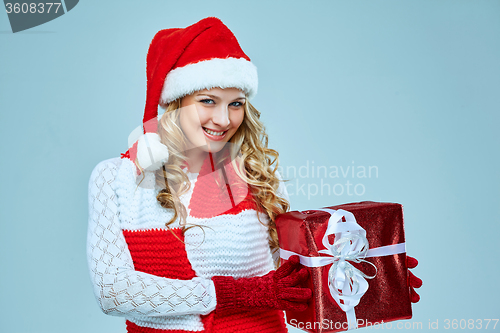 Image of Beautiful young woman in Santa Claus clothes