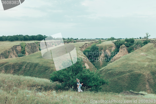 Image of The young mother and daughter on green grass background 