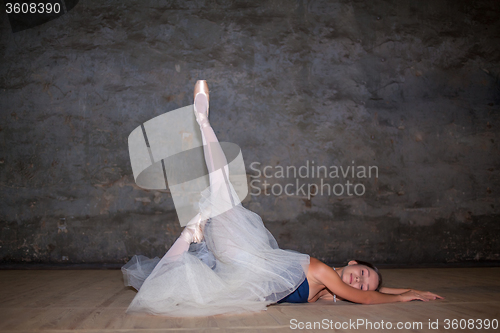 Image of The beautiful ballerina posing in long white skirt 