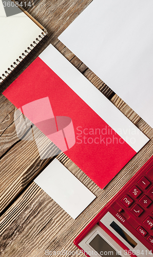 Image of The mockup on wooden background with red calculator